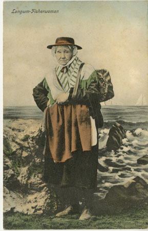 Coloured postcard of a Llangwm Fisherwoman standing on the river side